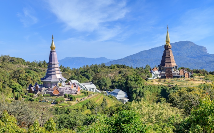Noppamethanedon and Nopphonphusiri pagodas on Kew Mae Pan trail, Doi Inthanon, surrounded by lush greenery.