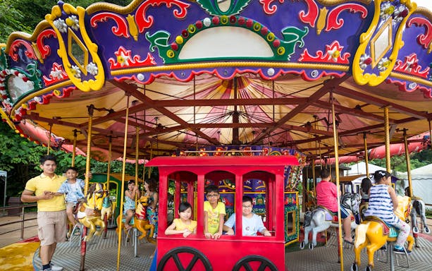 Children enjoying a colorful carousel ride at Sunway Lost World of Tambun.