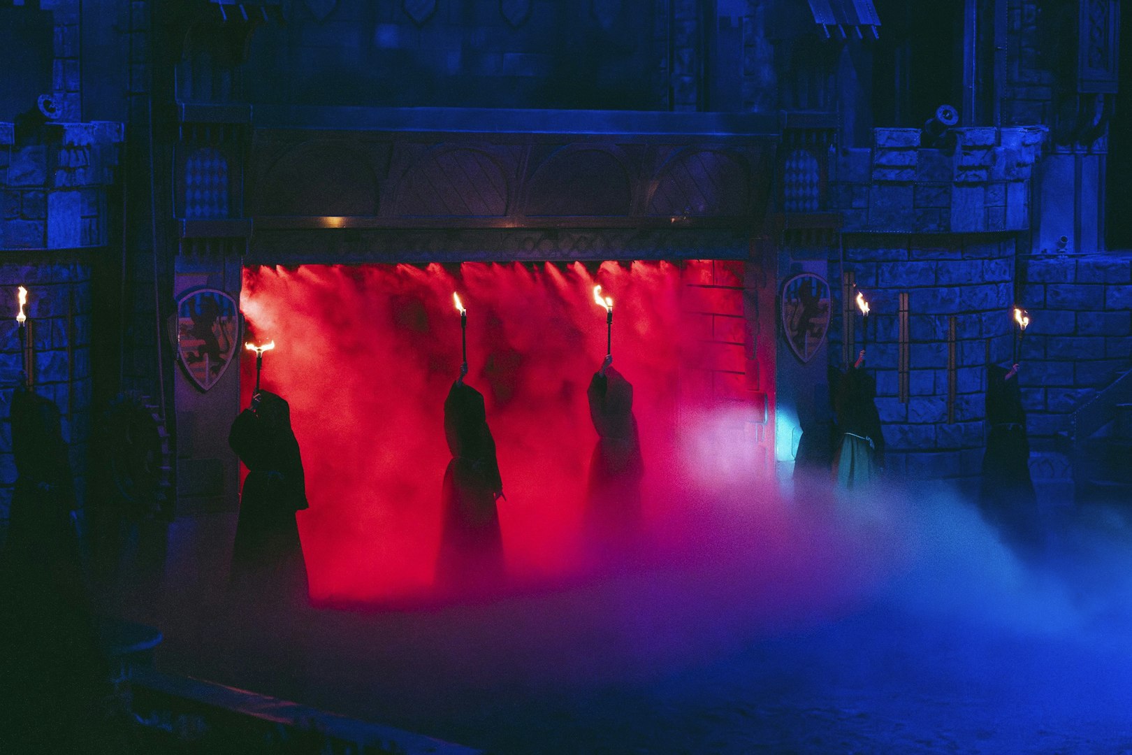 Performers with torches in red and blue mist at Tournament of Kings, Vegas show.