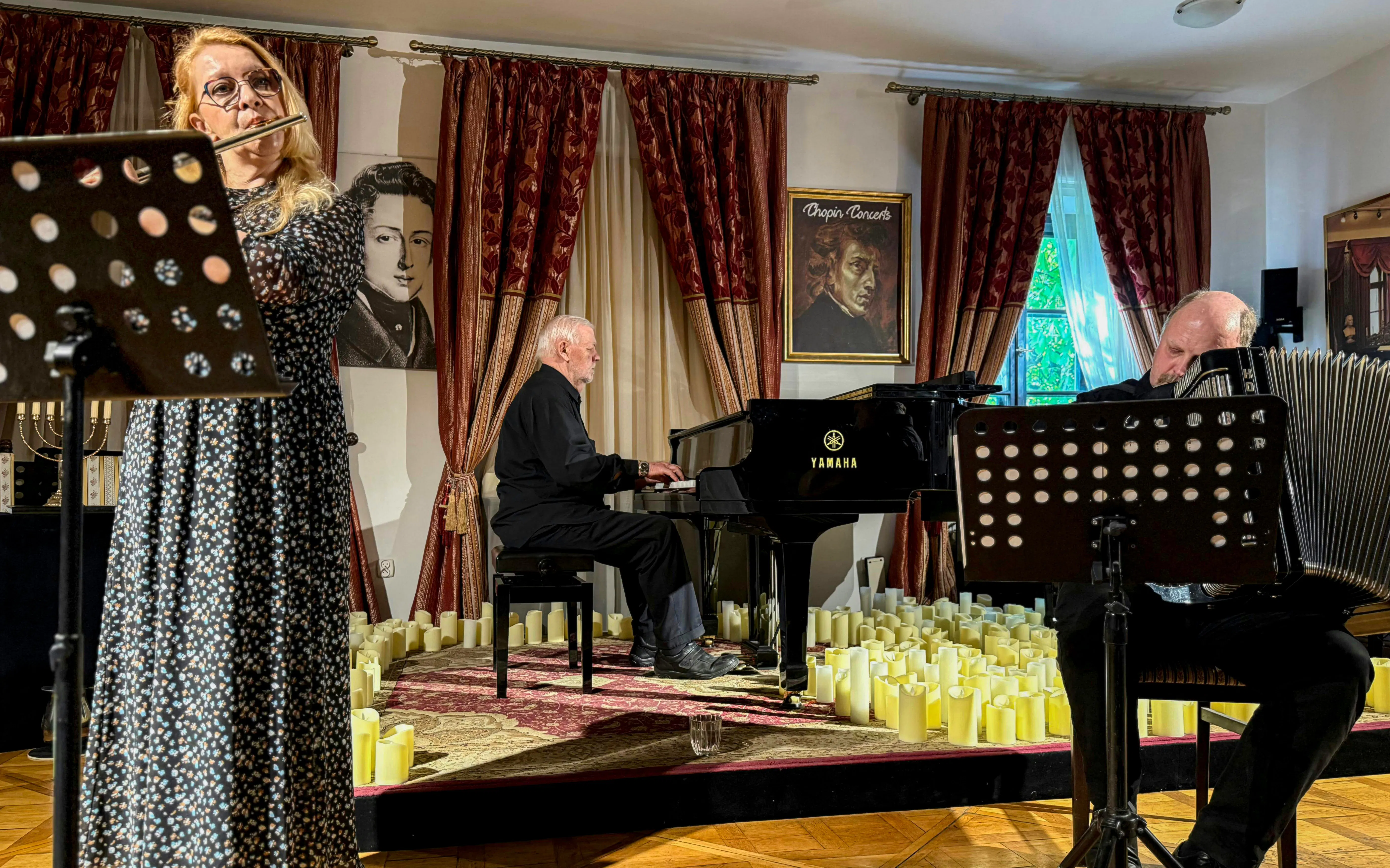 Klezmer musicians performing in Krakow concert hall with piano and flute.