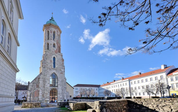 Church of Mary Magdalene tower in Budapest, Hungary, with surrounding historic buildings.