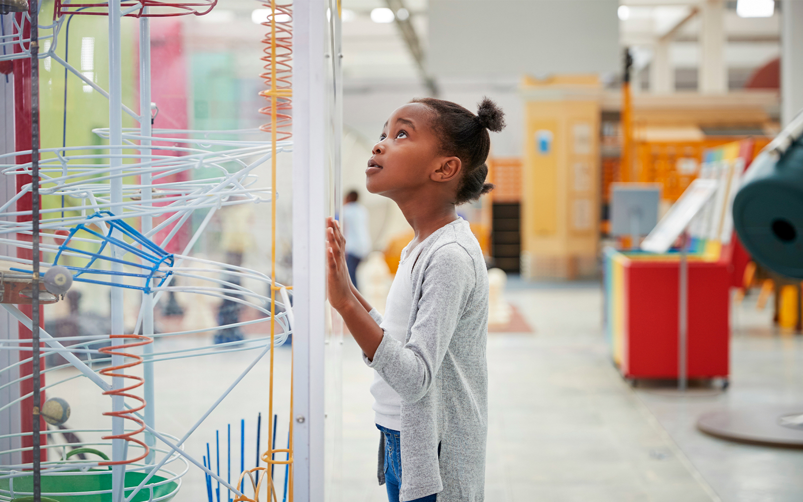 Young black girl looking at a science exhibit