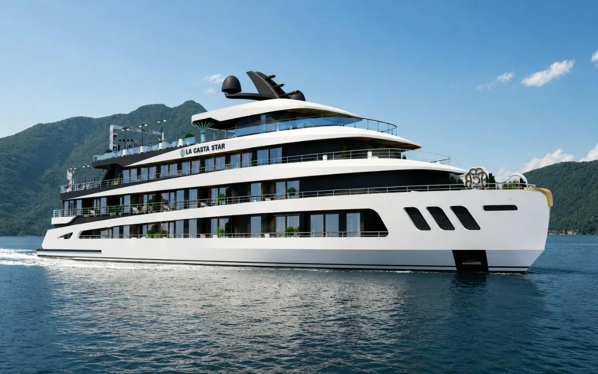 Luxury cruise ship on Ha Long Bay with mountainous backdrop.
