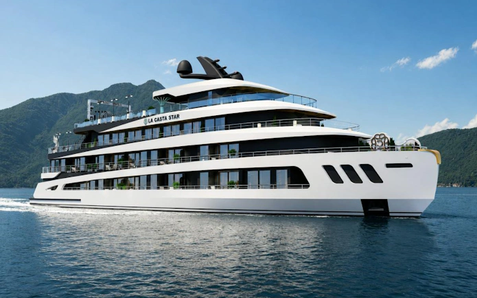 Luxury cruise ship on Ha Long Bay with mountainous backdrop.