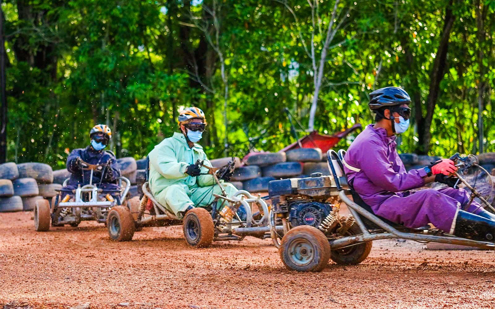 People racing go-karts at Batam Adventure Park track.
