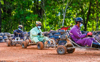 People racing go-karts at Batam Adventure Park track.