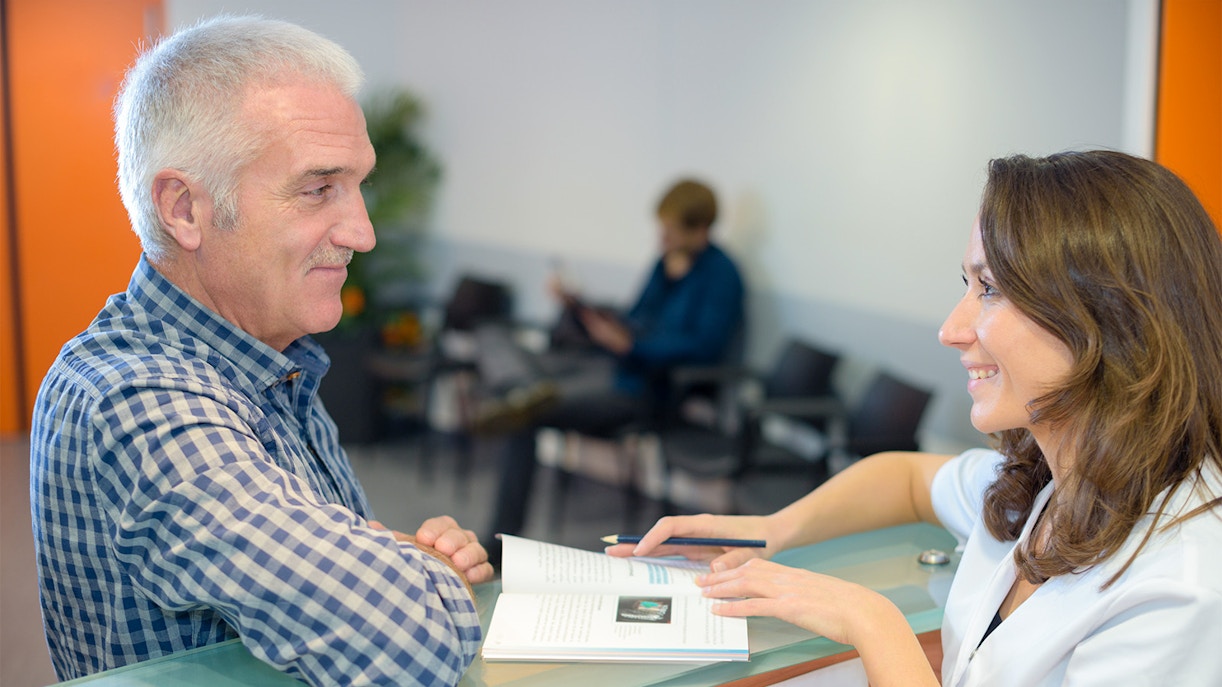 Tourist at Notre Dame sales desk in Paris purchasing tickets.