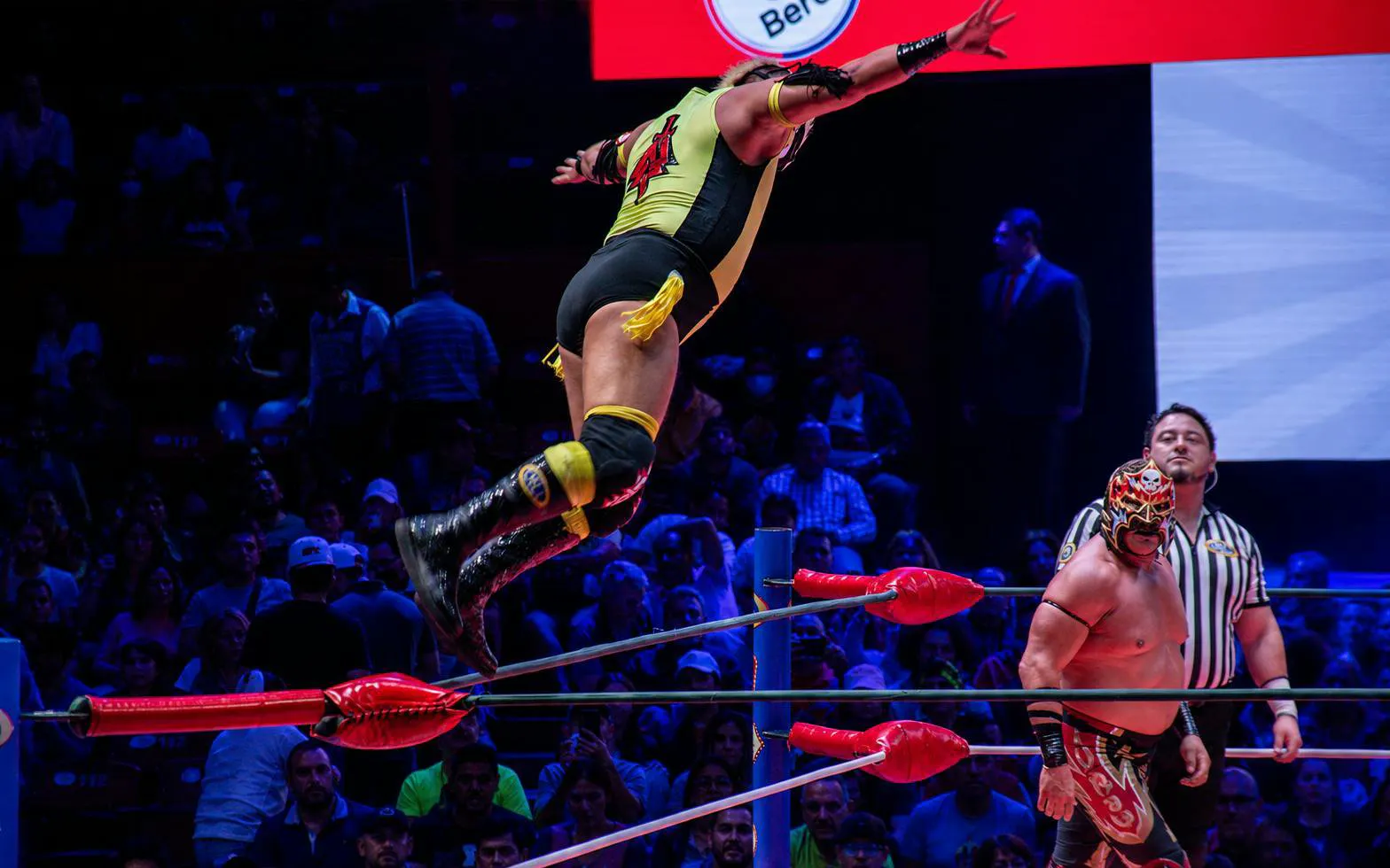 Luchador jumping from ropes during a match at Arena Mexico Lucha Libre.