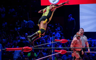 Luchador jumping from ropes during a match at Arena Mexico Lucha Libre.
