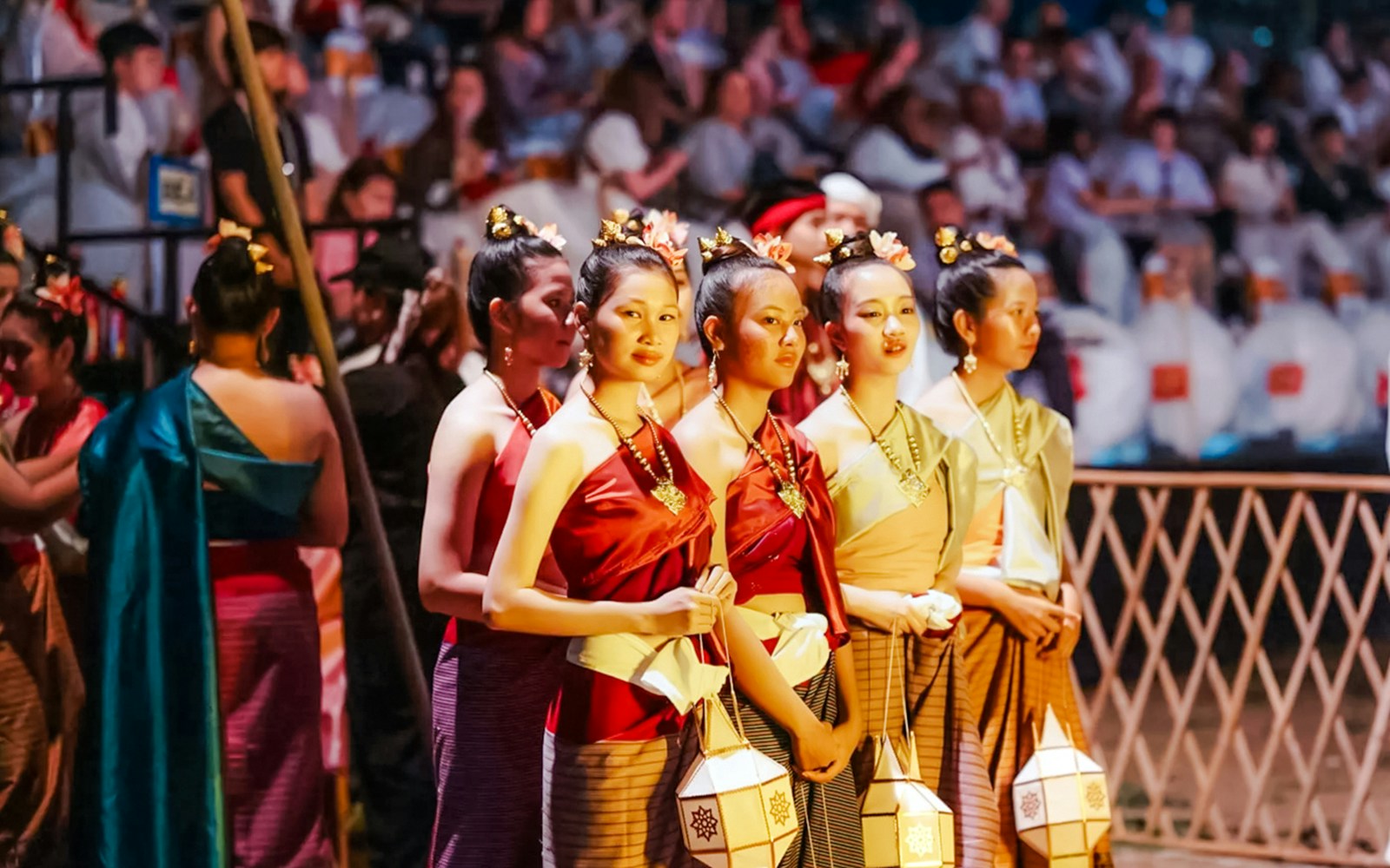 Yipeng Lantern Festival participant in traditional costume releasing lantern in Chiang Mai, Thailand.