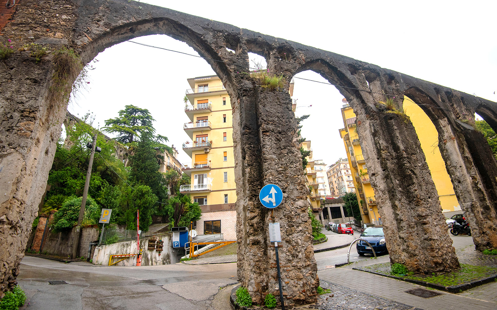 Salerno Medieval Aqueduct with lush greenery, part of Rome to Amalfi day trips.