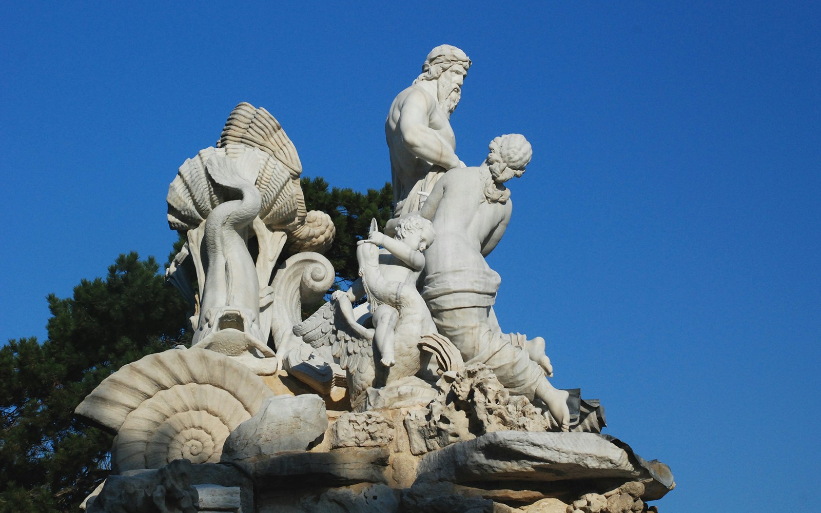 Neptune Fountain sculpture in Schonbrunn, Vienna, featuring mythological figures.