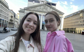 Two people in front of Théâtre Royal de la Monnaie, Brussels.