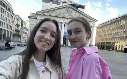 Two people in front of Théâtre Royal de la Monnaie, Brussels.