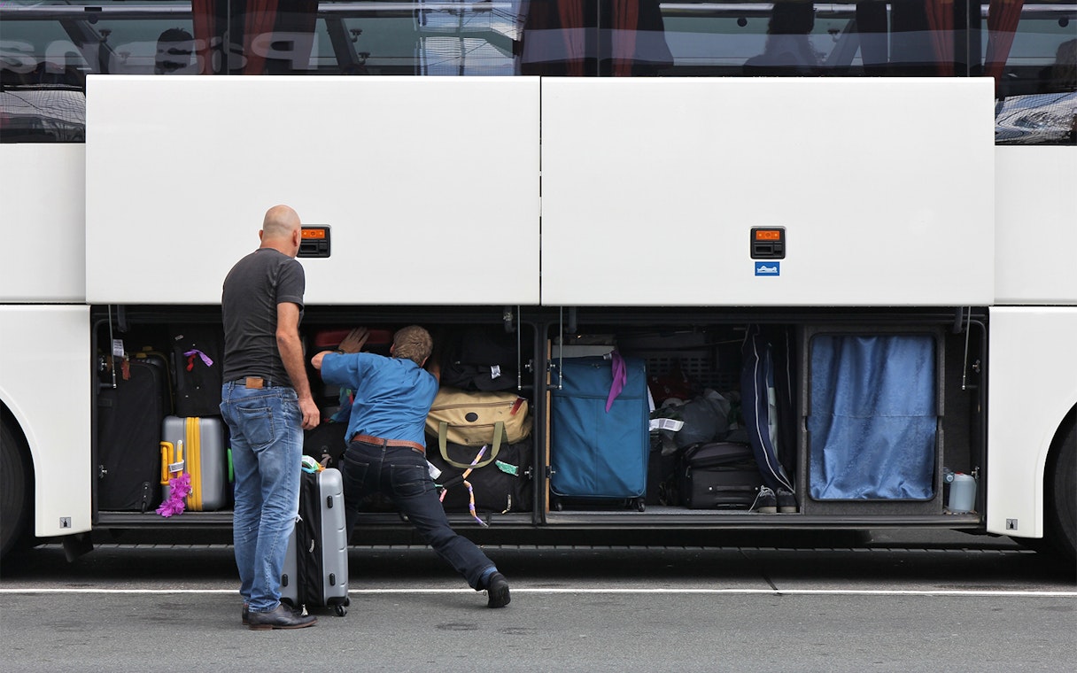 Passengers loading luggage into a bus compartment for Roma Linee one-way tickets from Rome Fiumicino Airport.