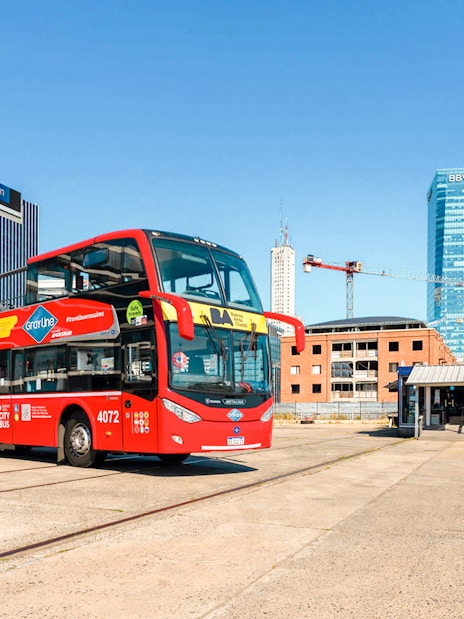 Gray Line City bus in front of Telecon building, Buenos Aires, hop on hop off tour.