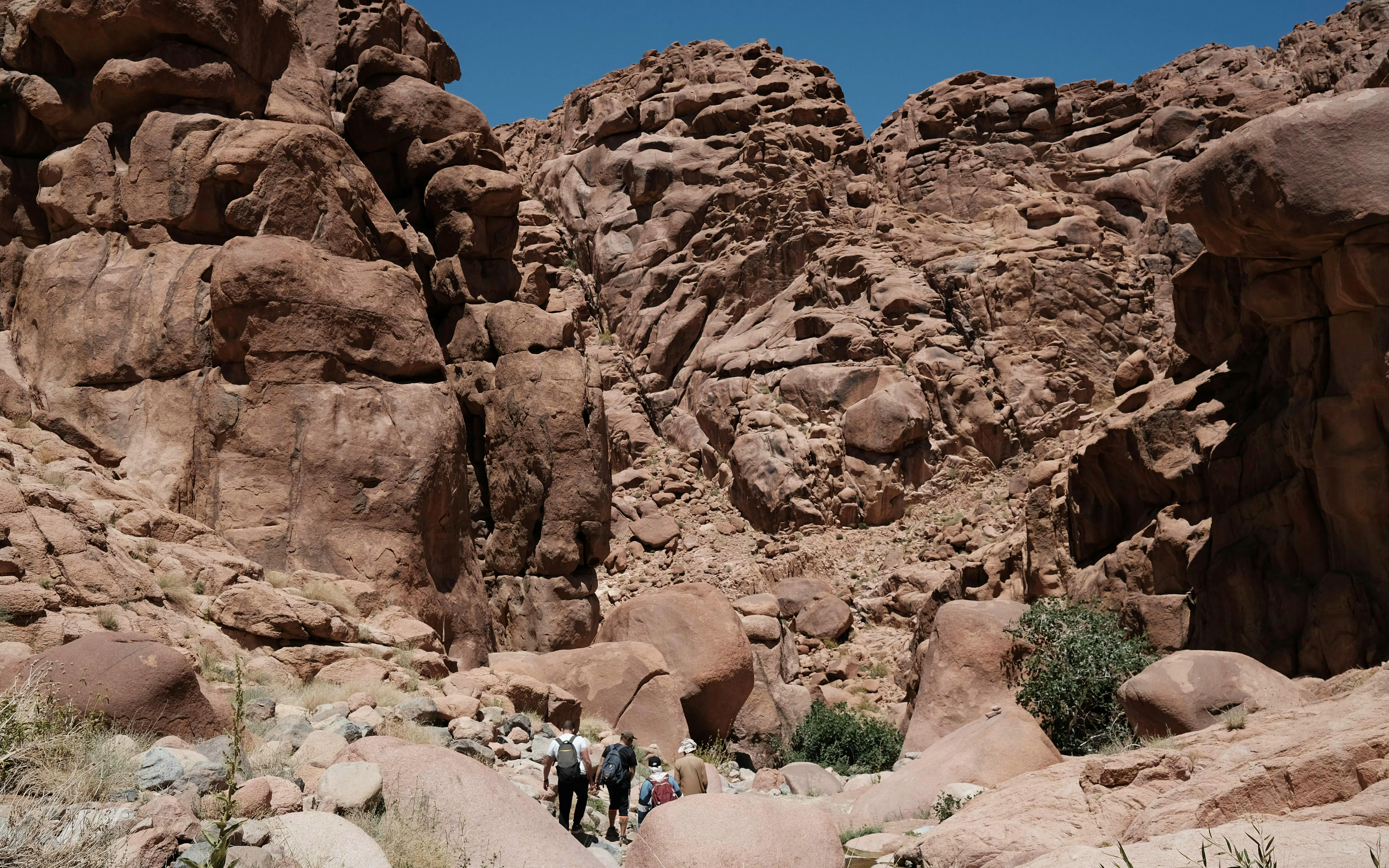Hikers exploring rocky terrain on Mount Sinai during a group tour.
