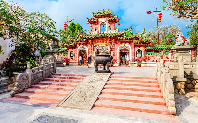 Fukian Assembly Hall entrance with red lanterns and intricate architecture in Hoi An.