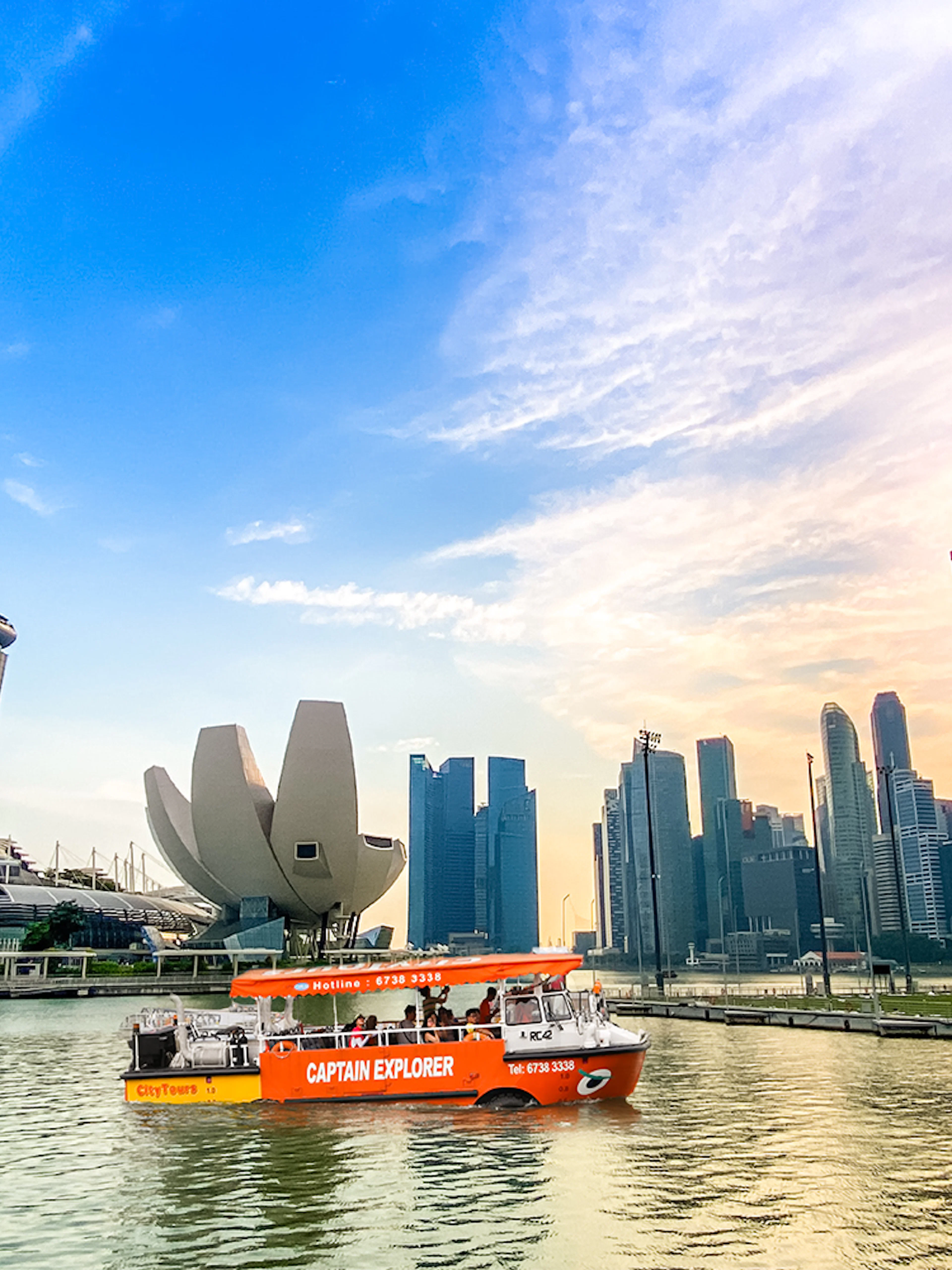 DUKW tour boat on Marina Bay with Singapore skyline and Marina Bay Sands.