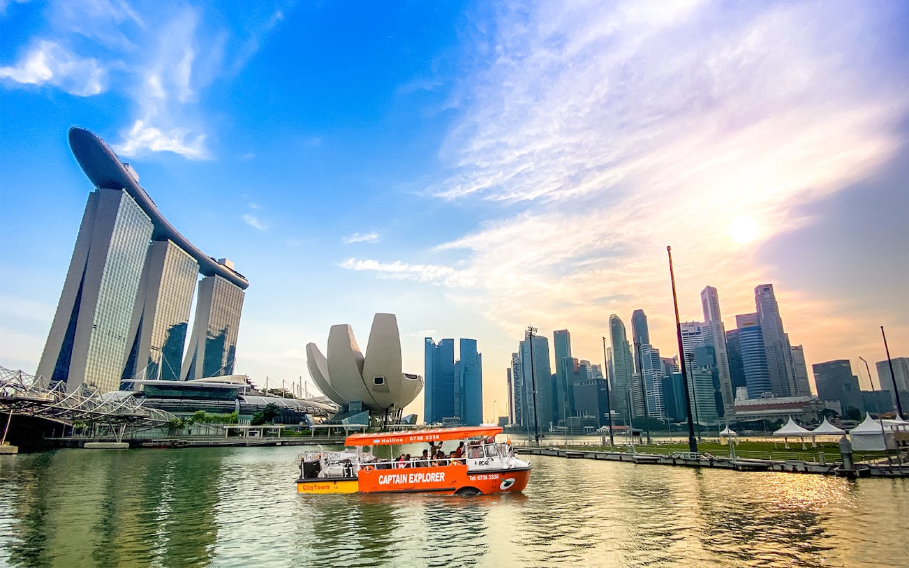DUKW tour boat on Marina Bay with Singapore skyline and Marina Bay Sands.