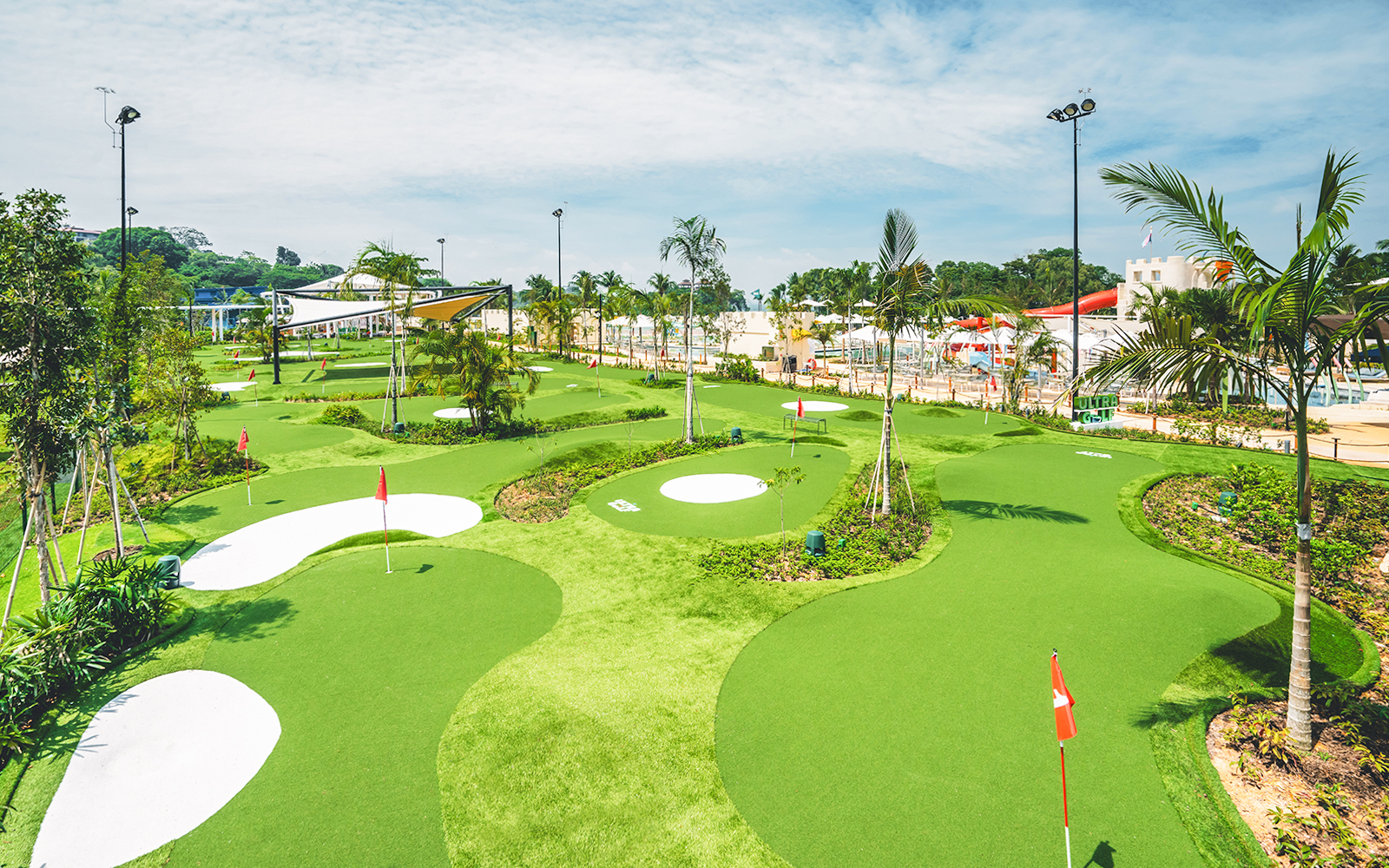 Mini-golf course with palm trees and flags, part of Combo: HyperDrive and UltraGolf experience.