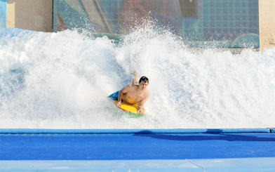 Surfer riding artificial wave at Yas Waterworld Abu Dhabi.