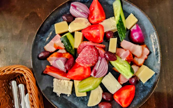 Traditional Romanian platter with cheese, meats, olives, and vegetables on the Taste of Bucharest tour.