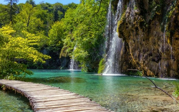 Wooden path beside waterfalls at Plitvice Lakes National Park, Croatia.