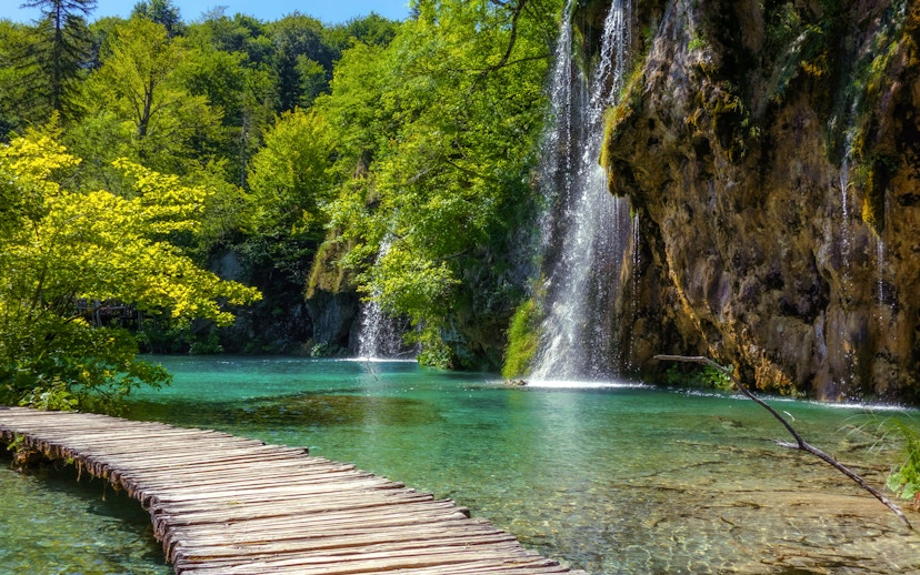 Wooden path beside waterfalls at Plitvice Lakes National Park, Croatia.