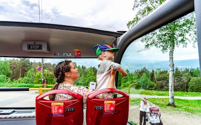 Mother and child enjoying view from top tier on Stavanger hop-on hop-off bus.