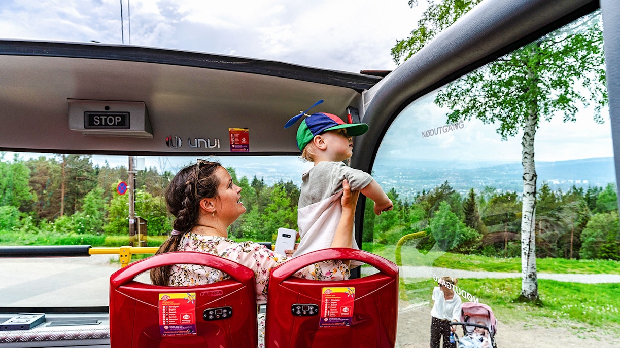 Mother and child enjoying view from top tier on Stavanger hop-on hop-off bus.