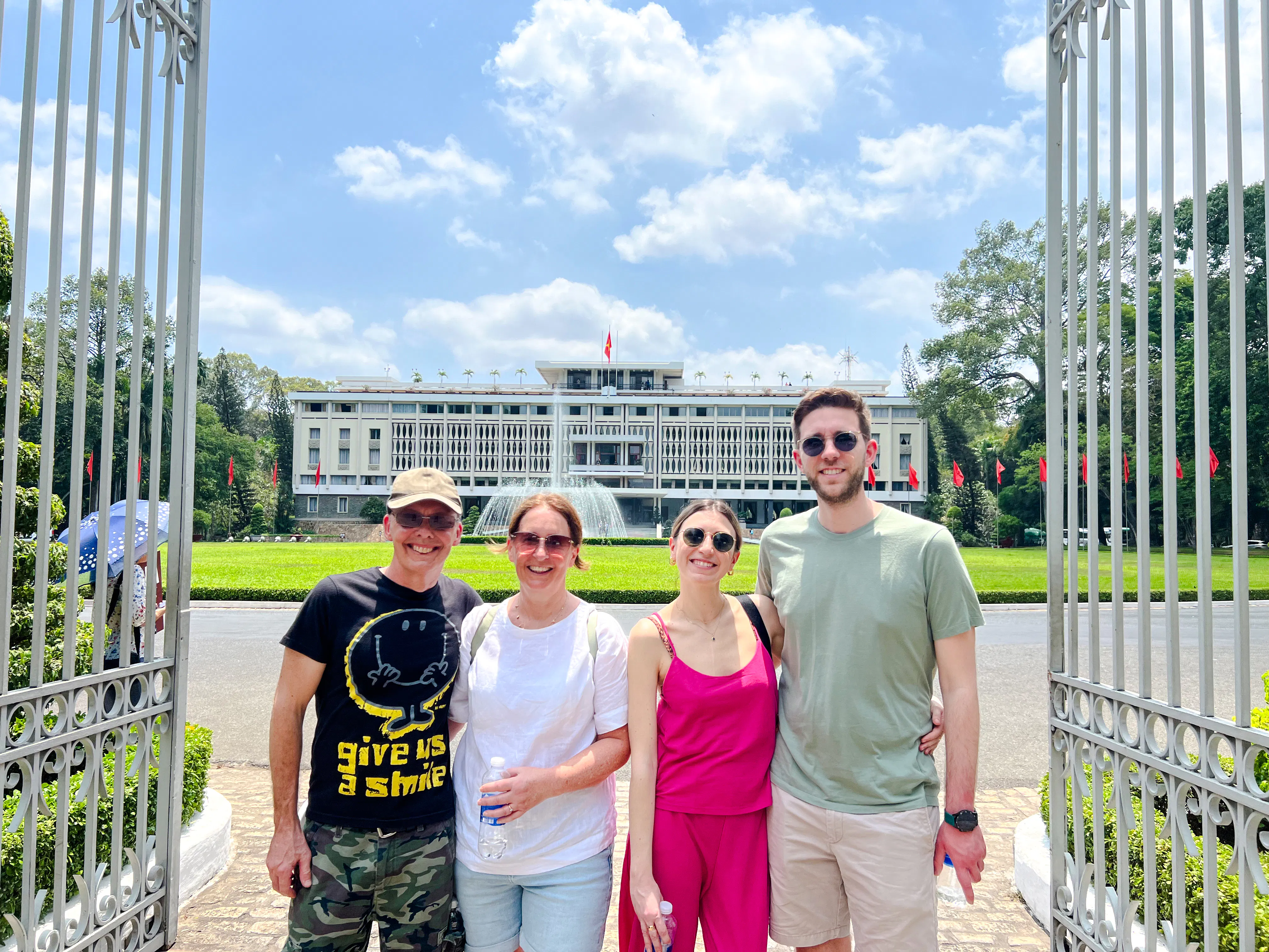 Group in front of Independence Palace fountain, Saigon, during cultural walking tour.