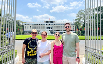 Group in front of Independence Palace fountain, Saigon, during cultural walking tour.