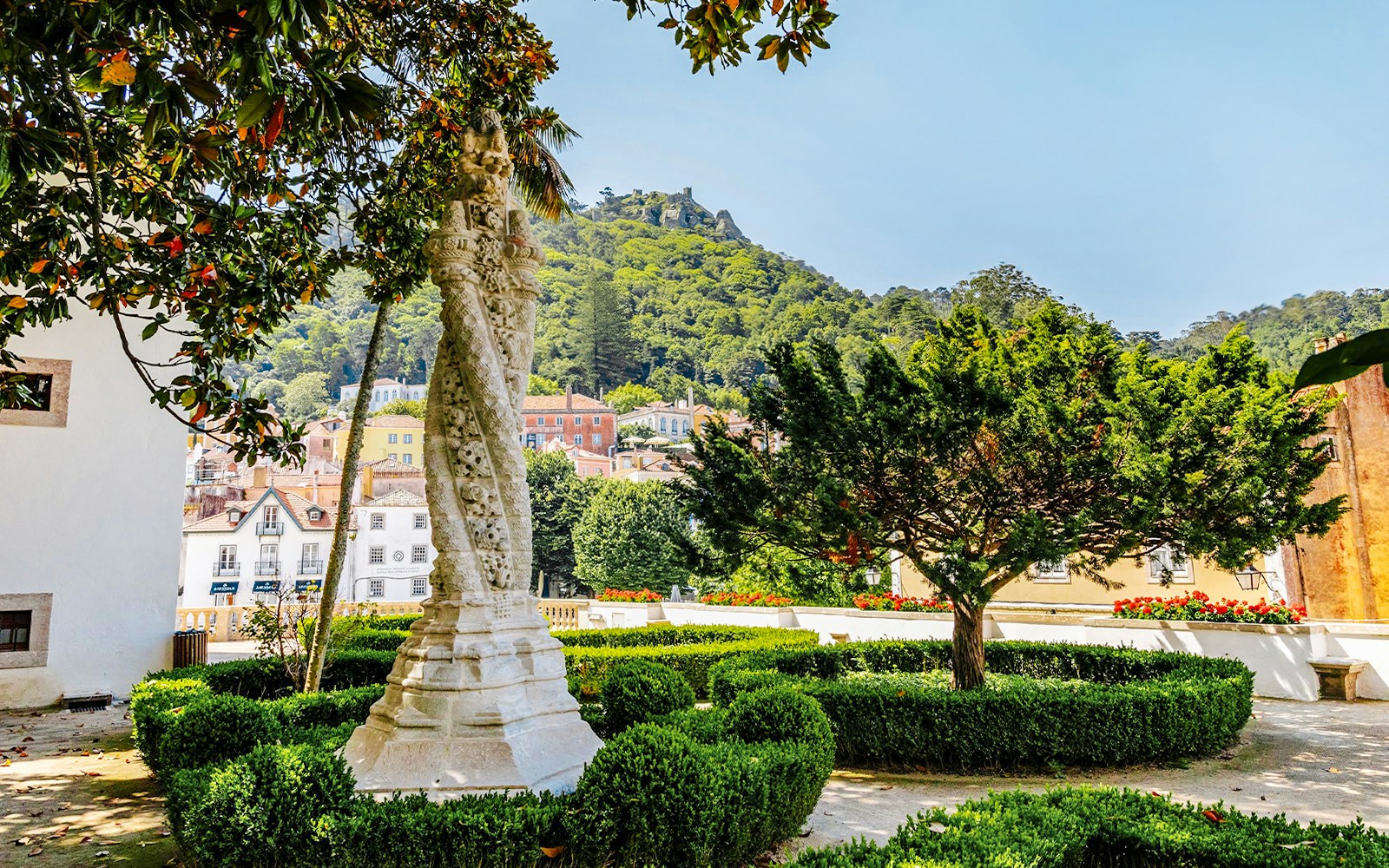Sintra National Palace Gardens with lush greenery and historic architecture in Sintra, Portugal.