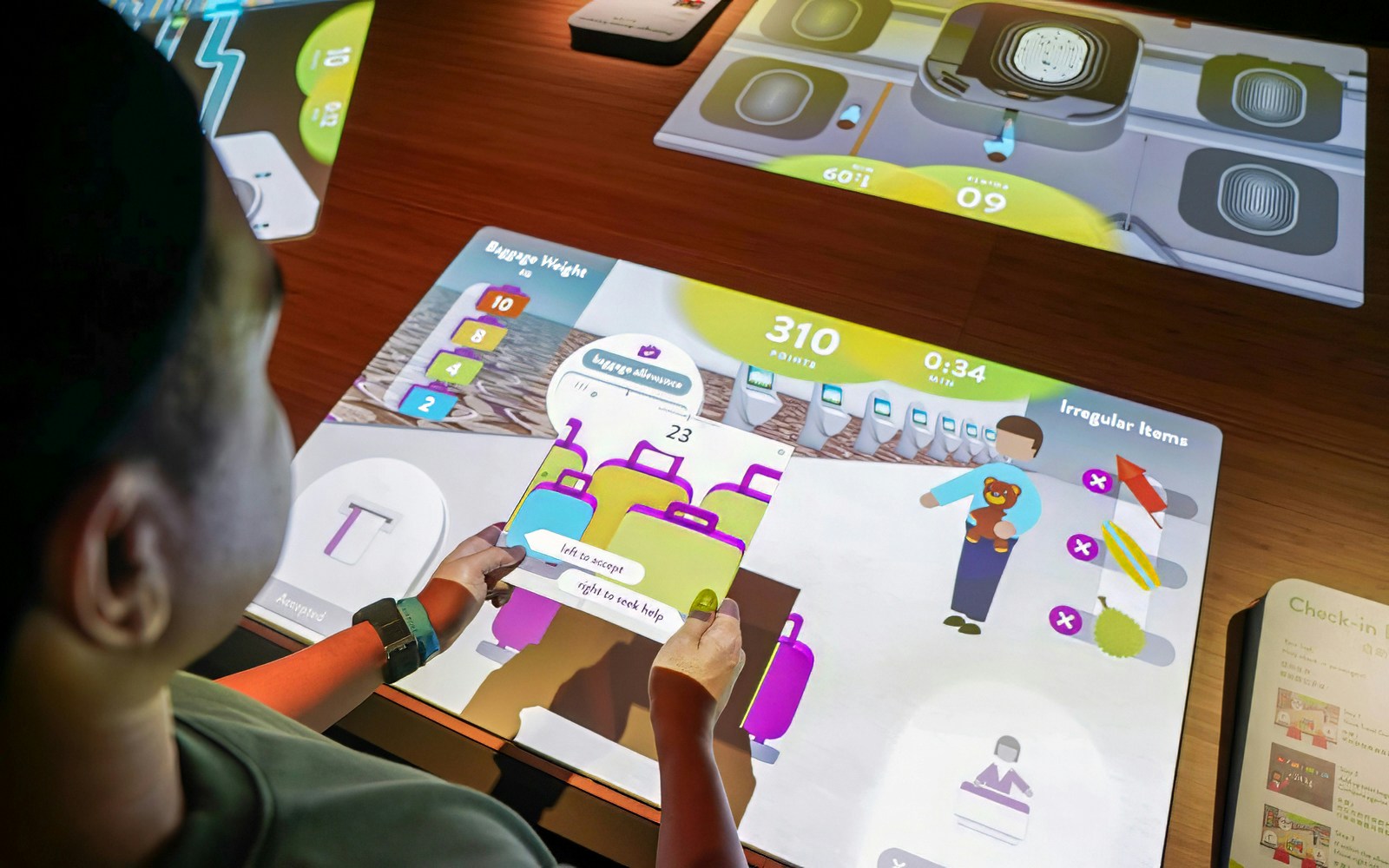 Man using an interactive exhibit at Changi Experience Studio.