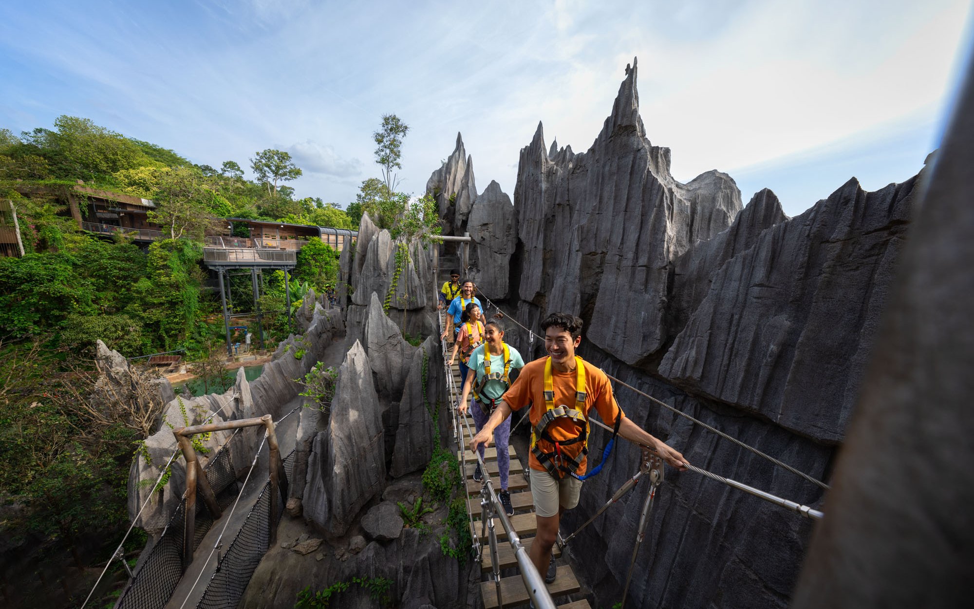 Visitors crossing a suspension bridge at Rainforest Wild Adventure.