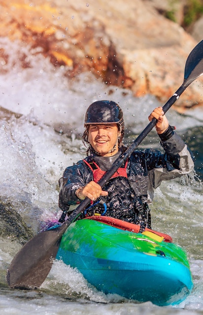 Tourists enjoying water sports on a sunny beach in Bali, Indonesia.