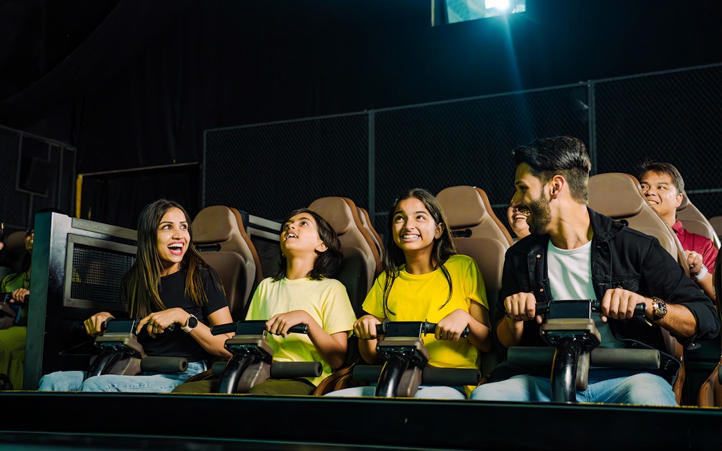 Family enjoying a thrilling ride at a theme park.