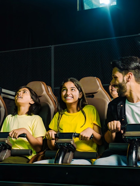 Family enjoying a thrilling ride at a theme park.