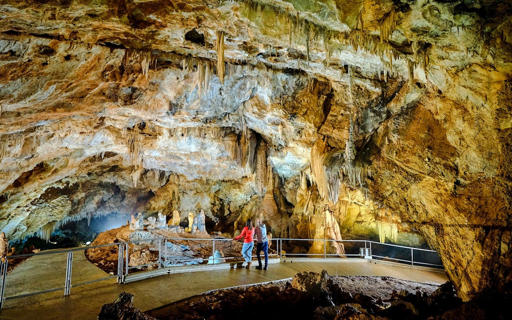 Tourists exploring stalactites inside Lipa Cave, Cetinje.