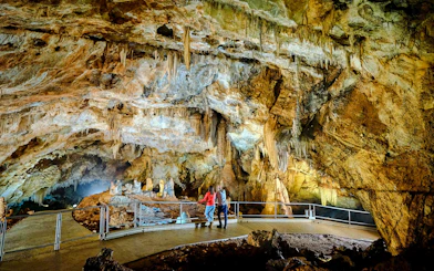 Tourists exploring stalactites inside Lipa Cave, Cetinje.