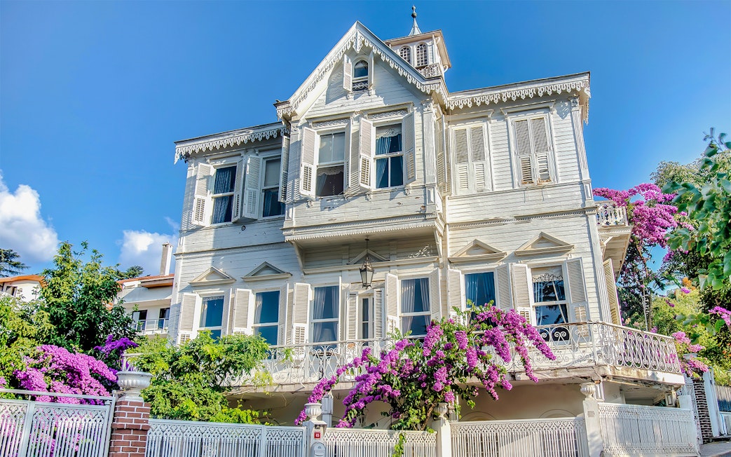 Traditional wooden house with shutters and bougainvillea on Princes Island, Turkey.