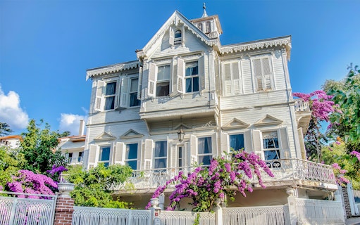 Traditional wooden house with shutters and bougainvillea on Princes Island, Turkey.