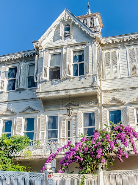 Traditional wooden house with shutters and bougainvillea on Princes Island, Turkey.