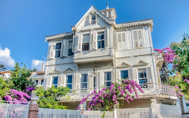 Traditional wooden house with shutters and bougainvillea on Princes Island, Turkey.