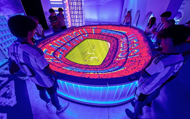 Visitors at interactive stadium display, The Messi Experience Dubai.