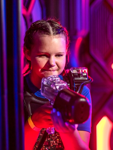 Child playing laser tag at Wonderworks.