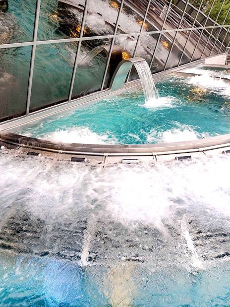 Inúu spa pool with cascading water feature at Caldea, Andorra.