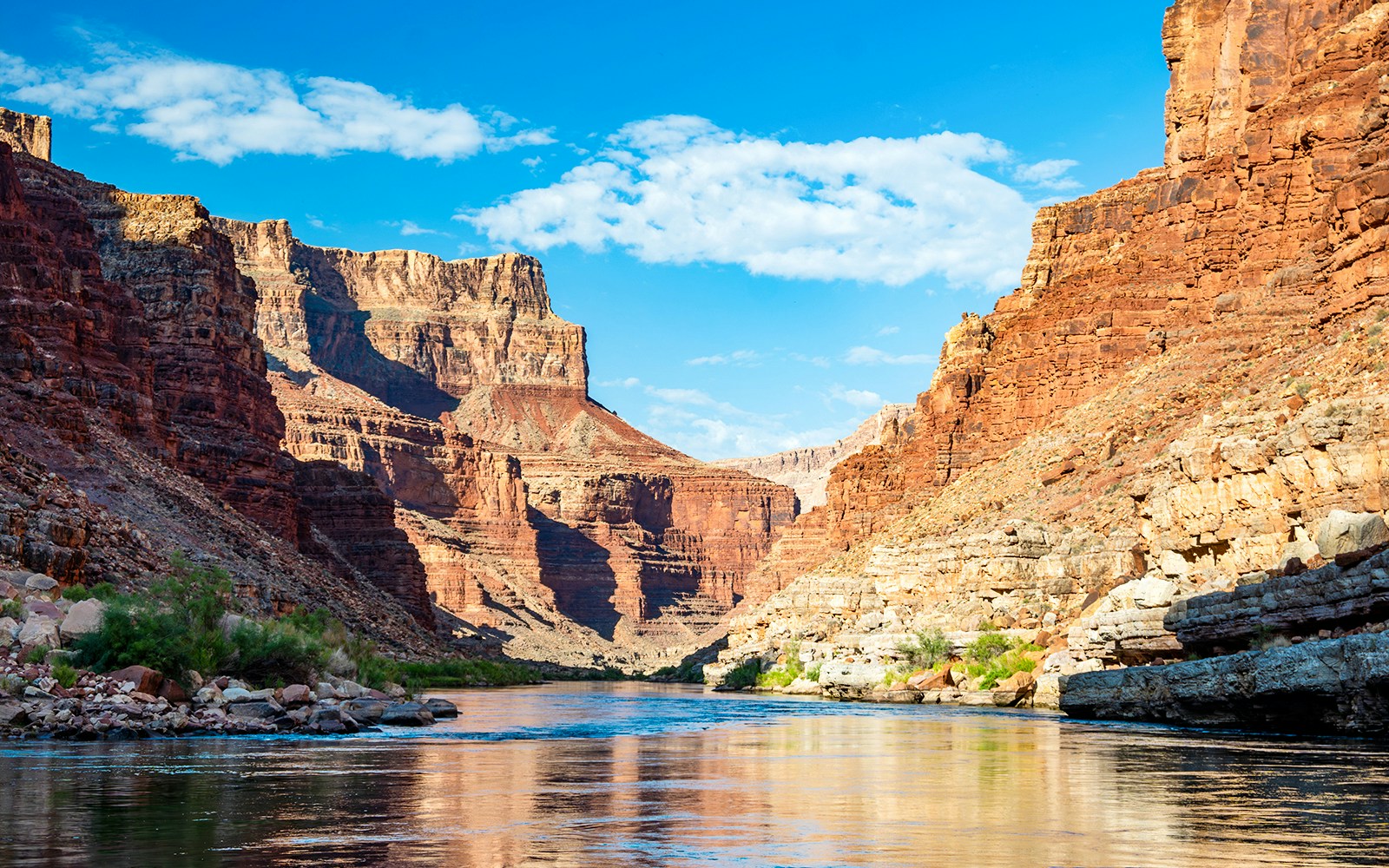 Colorado River winding through Grand Canyon, showcasing rugged cliffs and expansive landscape.