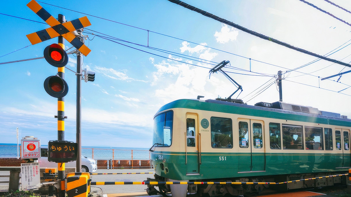 Enoshima Electric Railway train crossing near the coast in Kamakura, Japan.